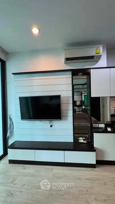 Modern living room with sleek TV unit and air conditioning, perfect for contemporary living.