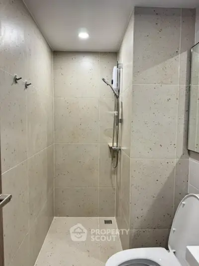 Modern bathroom with sleek shower and neutral tiles