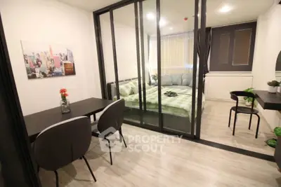 Modern studio apartment with glass partition, stylish decor, and cozy dining area.