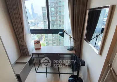 Modern study area with city view, featuring sleek desk and stylish lamp in high-rise apartment.