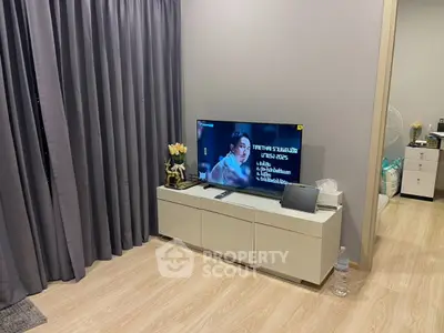 Modern living room with sleek TV stand and elegant decor, featuring a cozy ambiance and stylish curtains.