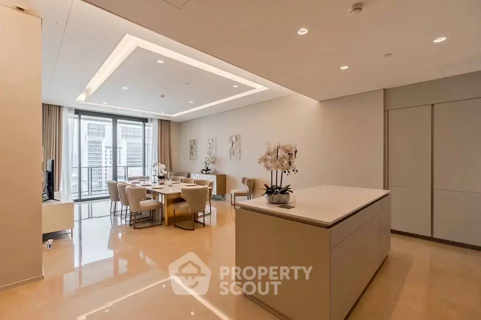 Luxurious open-plan living and dining area with modern kitchen island and elegant decor.