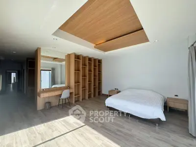 Spacious modern bedroom with built-in shelving and elegant wood accents