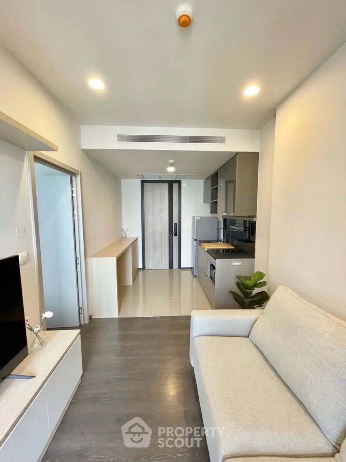 Modern living room with open kitchen layout and sleek design