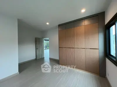 Spacious bedroom with built-in wardrobe and large window