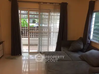 Cozy living room with large sliding glass doors leading to a private balcony.