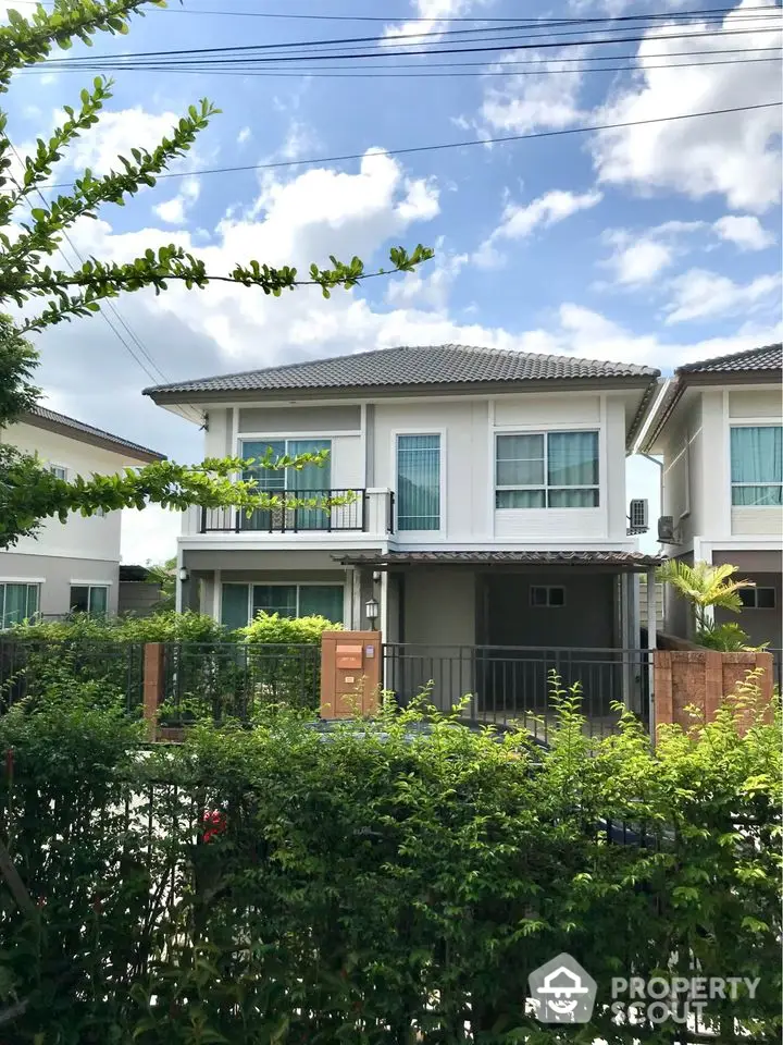 Charming two-story house with lush garden and modern design in a serene neighborhood.