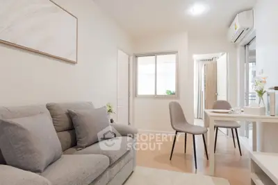 Modern living room with cozy sofa and dining area in a bright apartment.