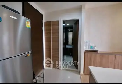 Modern kitchen with stainless steel fridge and sleek cabinetry