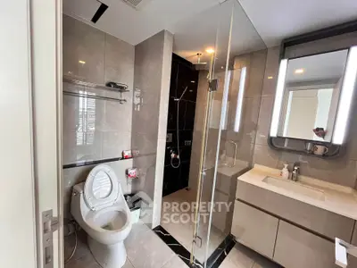Modern bathroom with sleek design, glass shower, and elegant fixtures in a luxury apartment.