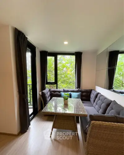 Charming living room with cozy seating and lush garden view, perfect for relaxation and entertaining.