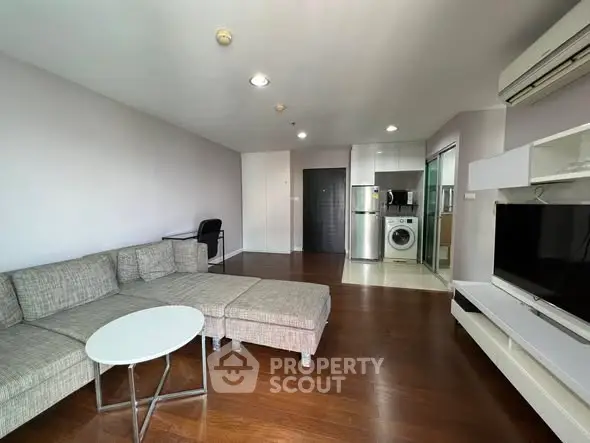 Spacious modern living room with open kitchen and sleek appliances