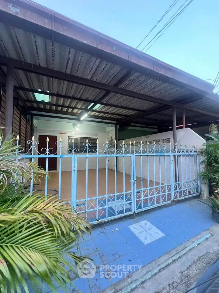 Charming single-story home with gated entrance and covered carport, perfect for cozy living.