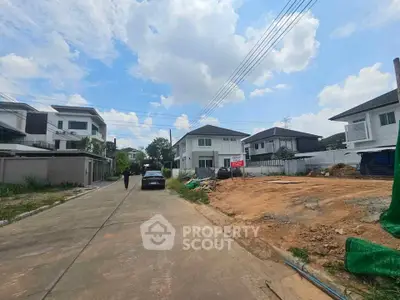 Charming suburban neighborhood with modern houses and clear blue skies, perfect for family living.