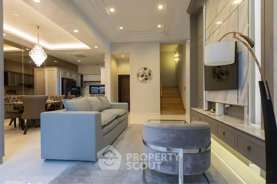 Luxurious open-plan living room with elegant decor and modern lighting