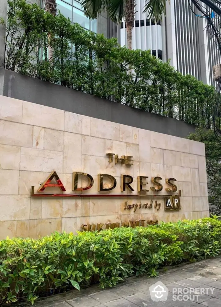 Luxurious entrance of The Address Sukhumvit with lush greenery and modern architecture.