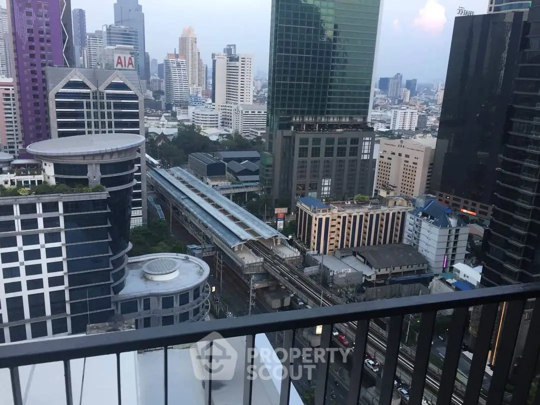 Stunning cityscape view from a high-rise balcony overlooking urban skyline and transit line.