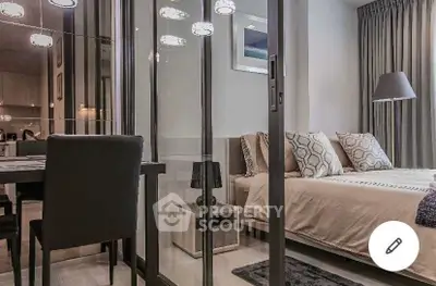 Modern bedroom with glass partition and elegant decor in a stylish apartment.