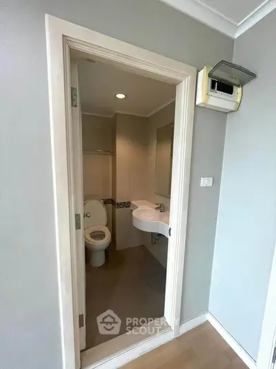 Compact bathroom with modern fixtures and neutral tones