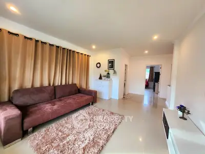 Spacious living room with plush brown sofa and elegant decor