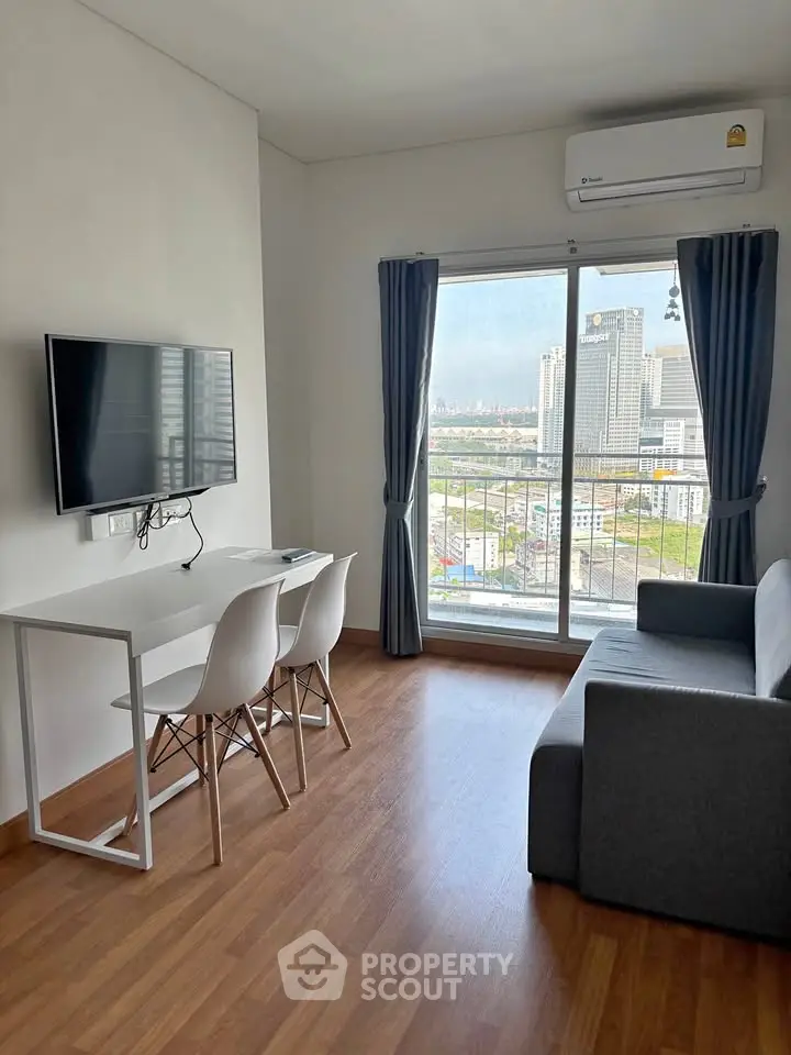 Modern living room with city view, featuring sleek furniture and large window.