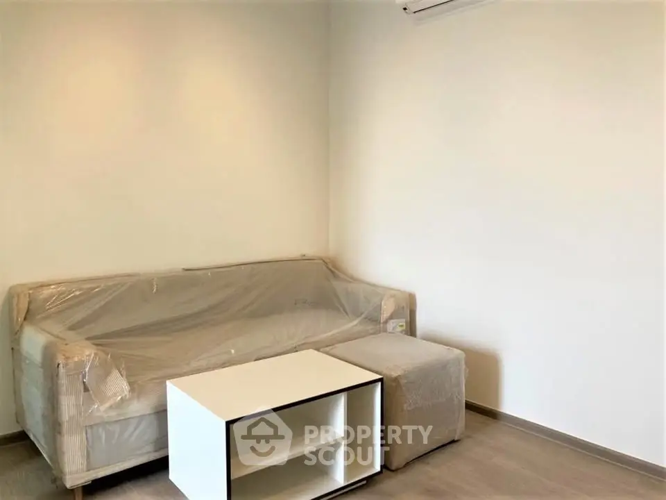 Minimalist living room with modern sofa and coffee table, perfect for cozy relaxation.