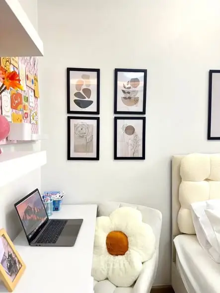 Cozy bedroom corner with modern decor and laptop workspace