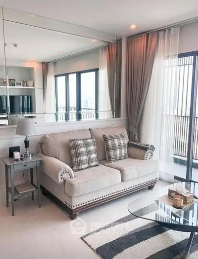 Elegant living room with plush sofa, large windows, and stylish decor in modern apartment.