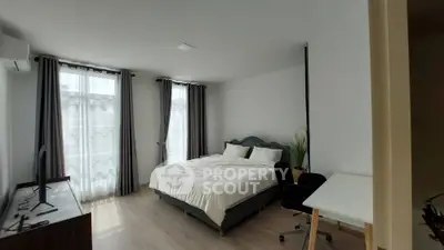 Spacious bedroom with modern decor and natural light