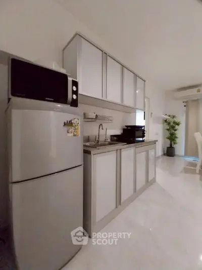 Modern kitchen with sleek cabinets and stainless steel appliances in a bright, airy space.