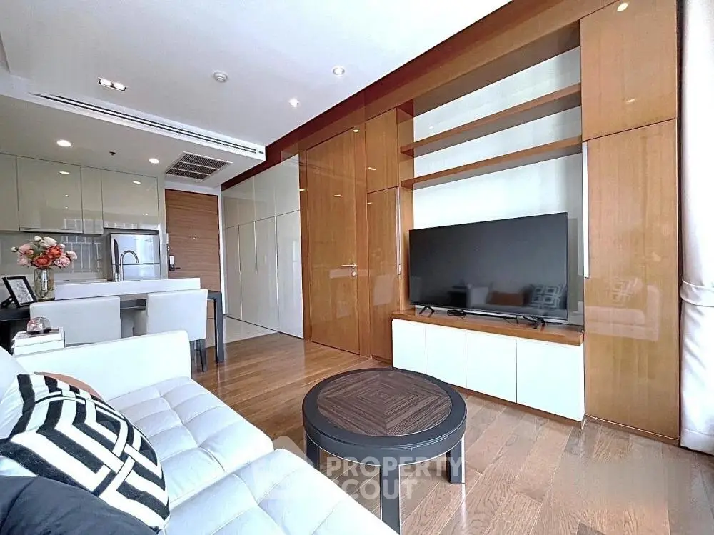 Modern living room with sleek design, open kitchen layout, and stylish furnishings in a contemporary apartment.