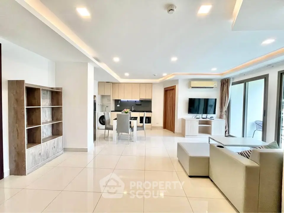 Spacious modern living room with open kitchen and elegant furnishings