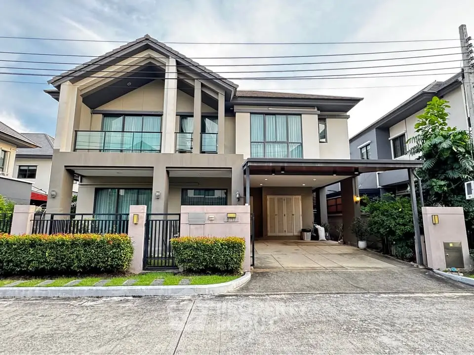 Modern two-story house with spacious driveway and lush greenery