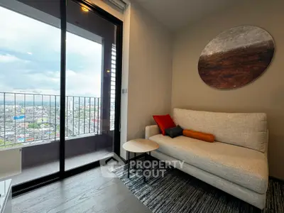 Modern living room with cozy sofa and city view balcony