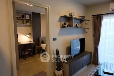 Modern living room with TV and view into cozy bedroom