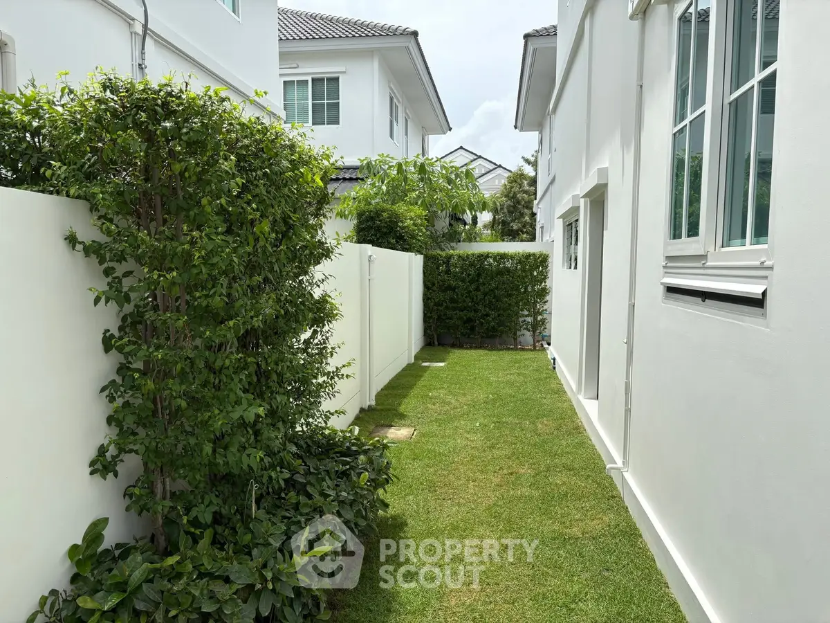 Charming side garden with lush greenery in modern residential property