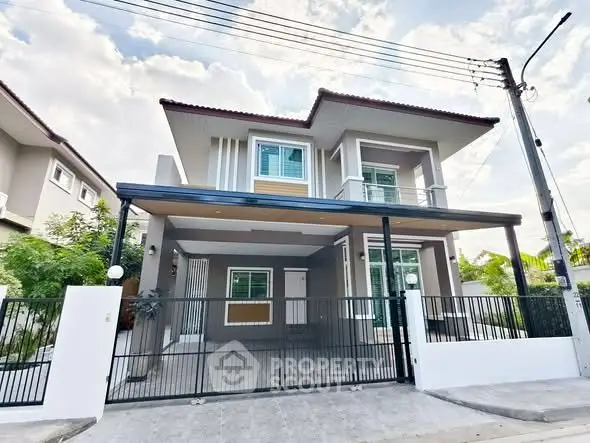 Modern two-story house with gated entrance and spacious driveway