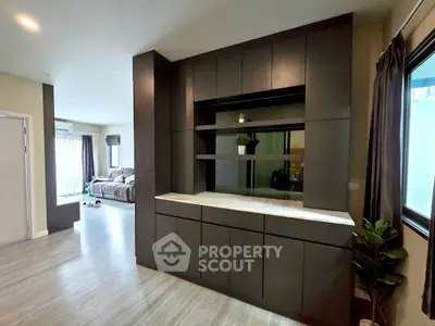 Spacious modern living room with sleek built-in storage and natural light