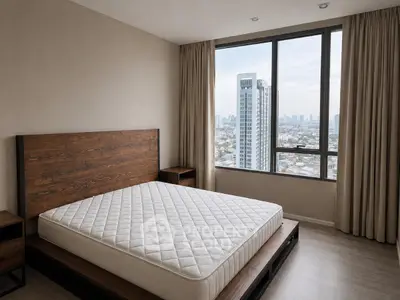 Spacious bedroom with city view and modern wooden furniture