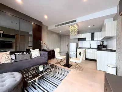 Modern open-layout living room with stylish kitchen and elegant decor