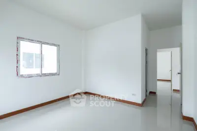 Spacious empty room with glossy white tiles and natural light