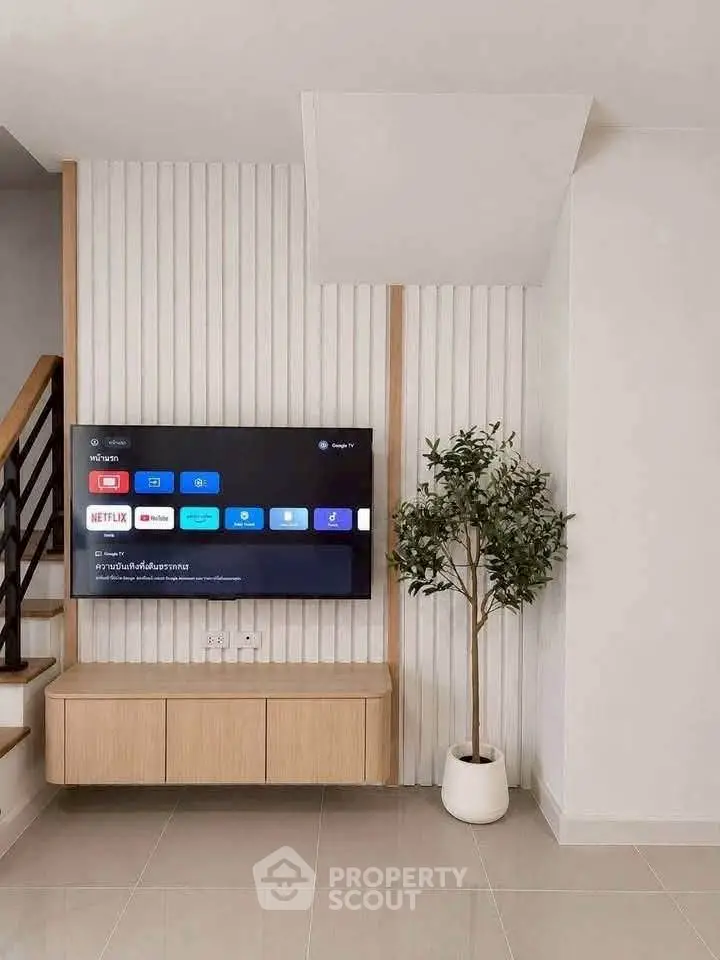 Modern living room with wall-mounted TV and stylish decor