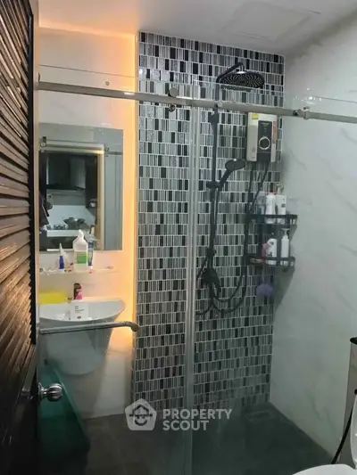 Modern bathroom with glass shower and stylish tile design