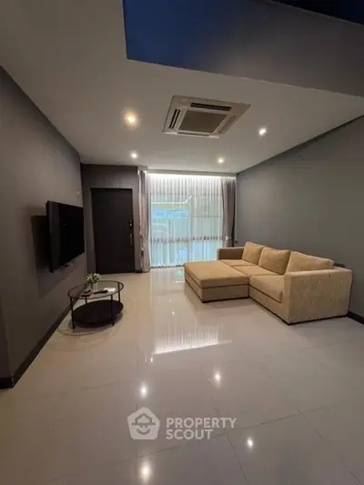 Modern living room with sleek design and cozy seating area.