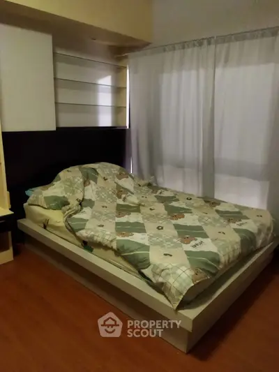 Cozy bedroom with modern bed and wooden flooring, perfect for relaxation.