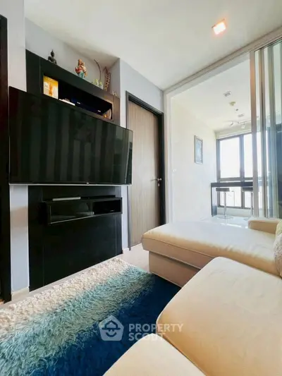 Modern living room with sleek TV setup and cozy seating area