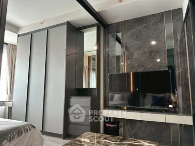 Luxurious modern bedroom with sleek wardrobe and marble TV wall