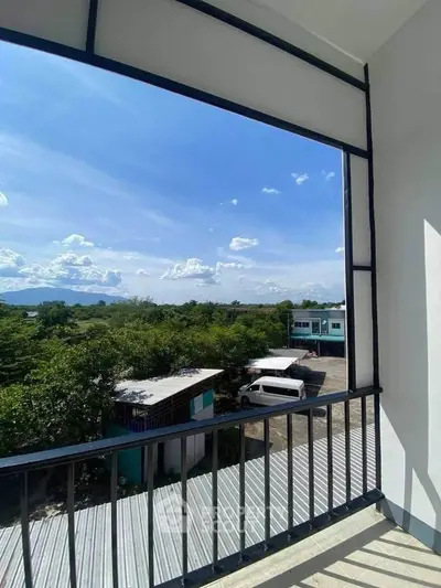 Stunning balcony view with lush greenery and clear blue sky
