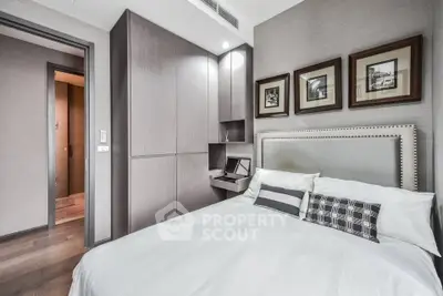 Modern bedroom with stylish decor and built-in storage in a luxury apartment.