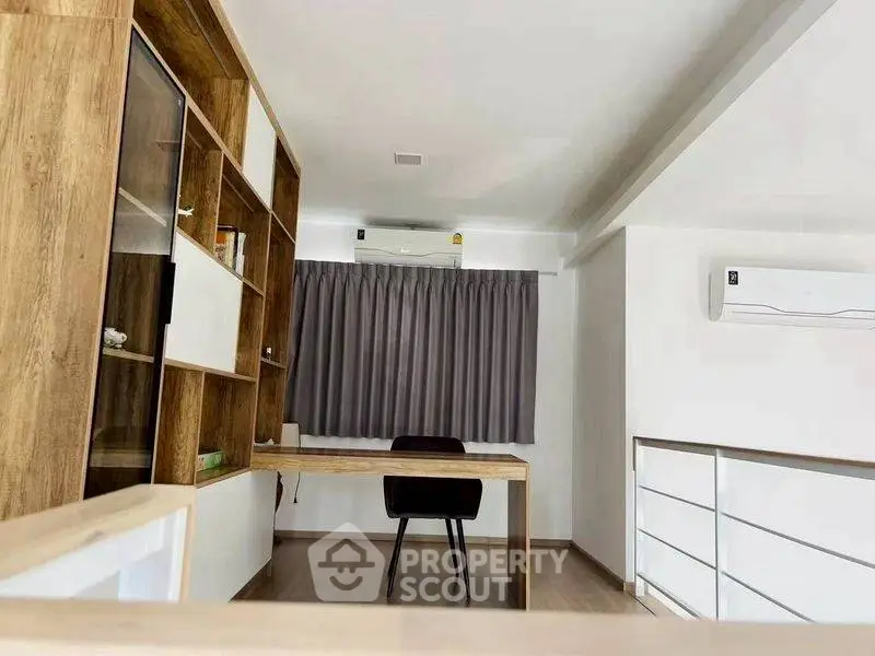 Modern study room with wooden desk and shelves, featuring air conditioning and sleek design.